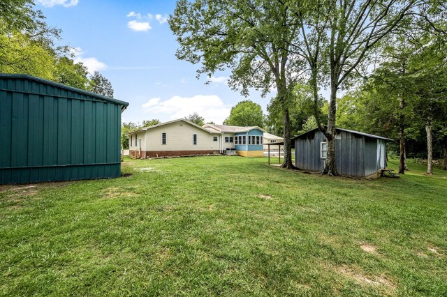 view of yard featuring an outbuilding and a storage unit