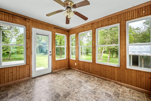 unfurnished sunroom featuring a ceiling fan