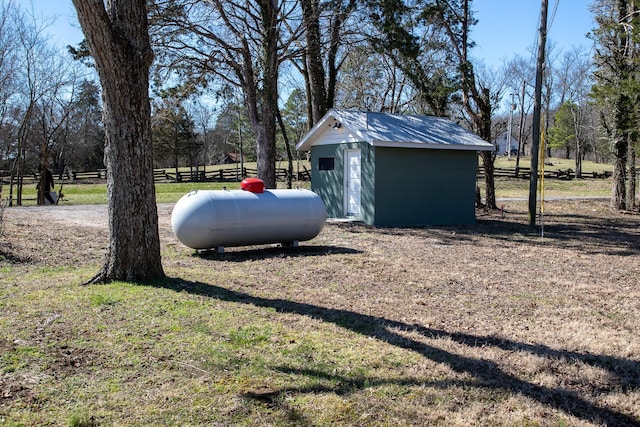 view of yard with an outbuilding, a shed, and fence