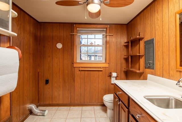 bathroom with vanity, ceiling fan, wood walls, tile patterned floors, and toilet