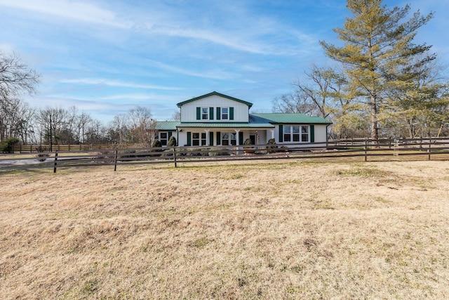 view of front of home featuring covered porch, fence, and metal roof