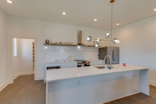 kitchen with wall chimney range hood, dark wood-style floors, stainless steel appliances, and a sink