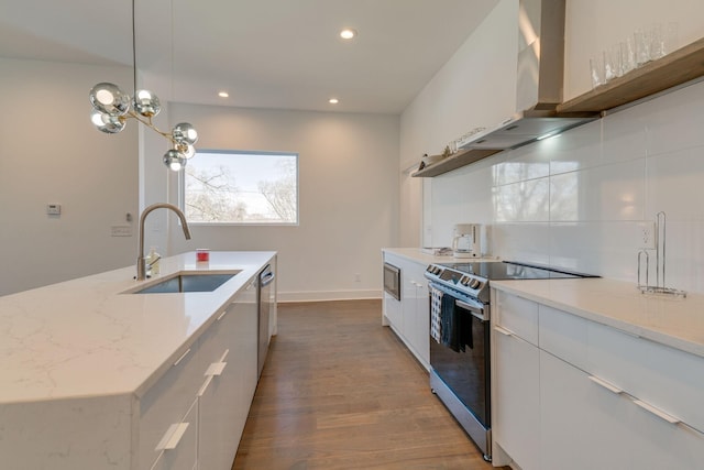 kitchen with a sink, white cabinets, appliances with stainless steel finishes, wall chimney exhaust hood, and modern cabinets