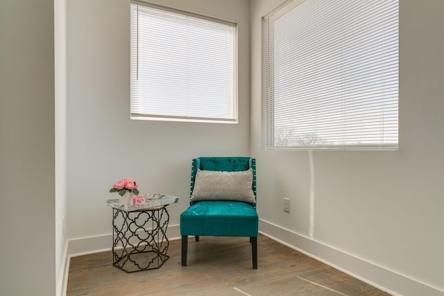 sitting room featuring baseboards and wood finished floors