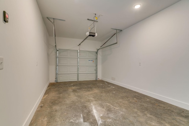 garage with baseboards and a garage door opener