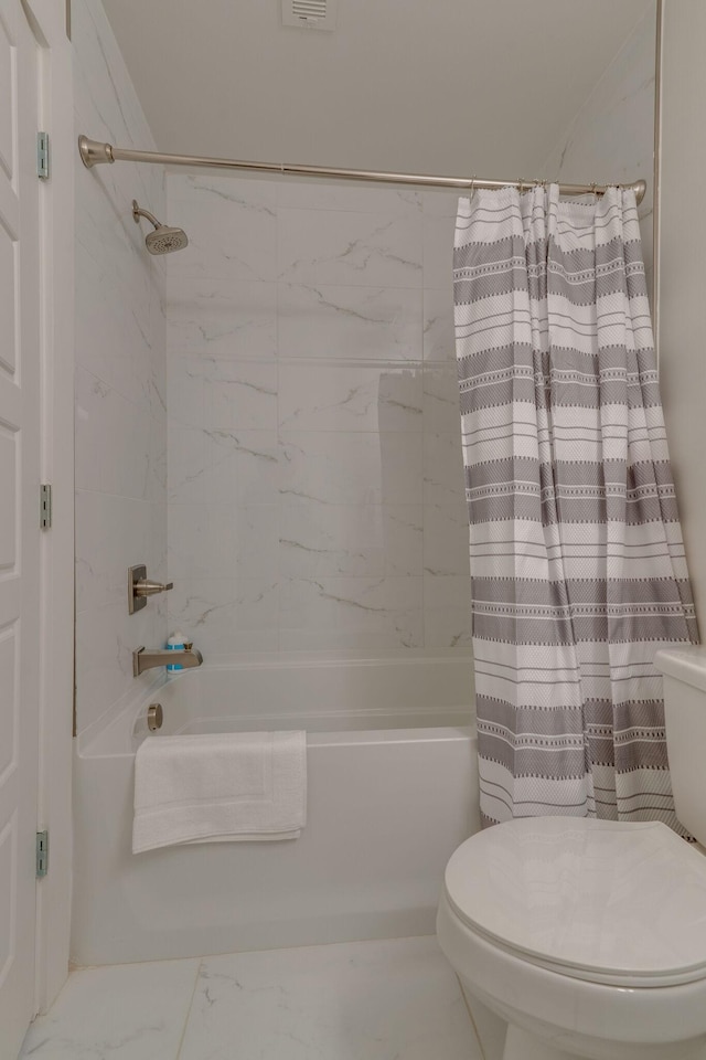 full bath featuring shower / bath combo with shower curtain and toilet