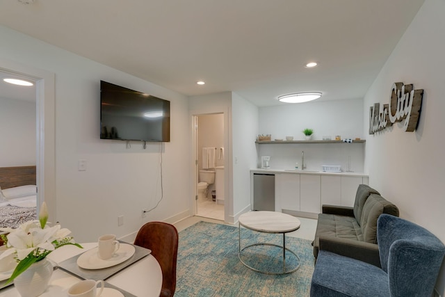 living room featuring baseboards, light tile patterned flooring, and recessed lighting