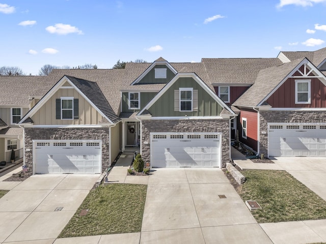 craftsman house featuring driveway, a shingled roof, and board and batten siding