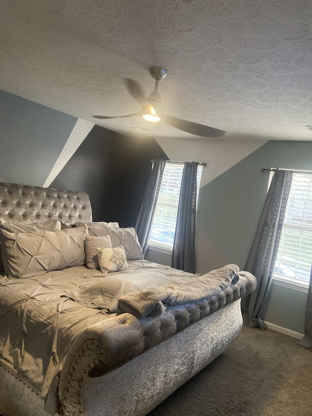 carpeted bedroom featuring a textured ceiling, ceiling fan, lofted ceiling, and baseboards