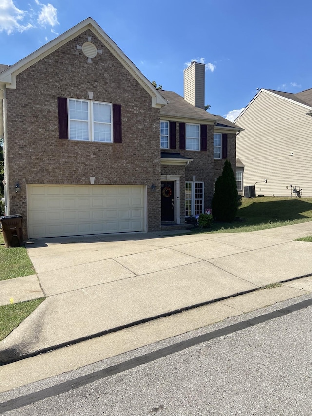 traditional-style house with brick siding, a chimney, central AC unit, a garage, and driveway