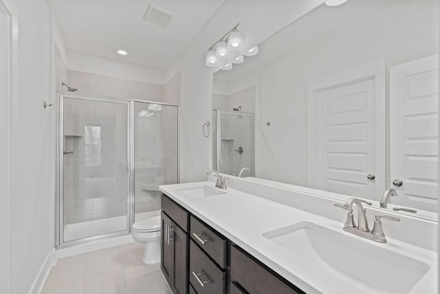 bathroom with toilet, a sink, visible vents, and a shower stall