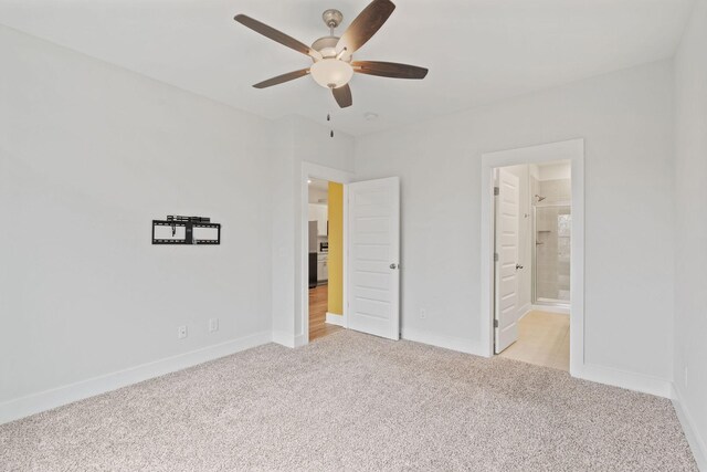 unfurnished bedroom featuring baseboards and light colored carpet