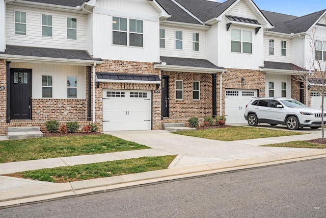 multi unit property featuring an attached garage, roof with shingles, concrete driveway, and brick siding