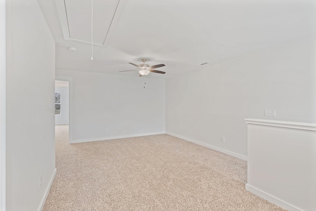 carpeted spare room featuring attic access, visible vents, and baseboards