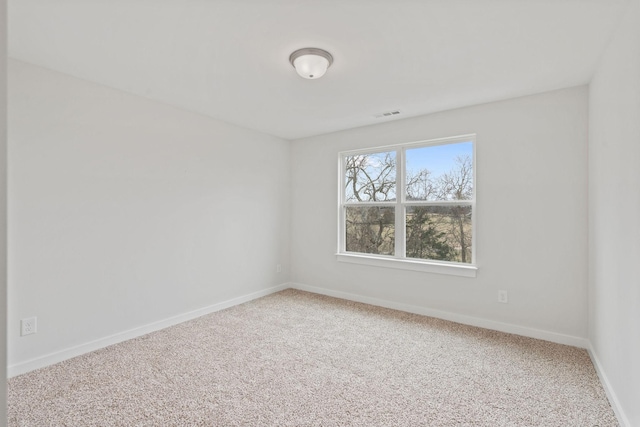 empty room with visible vents, baseboards, and carpet flooring