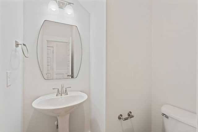 bathroom with toilet and a sink