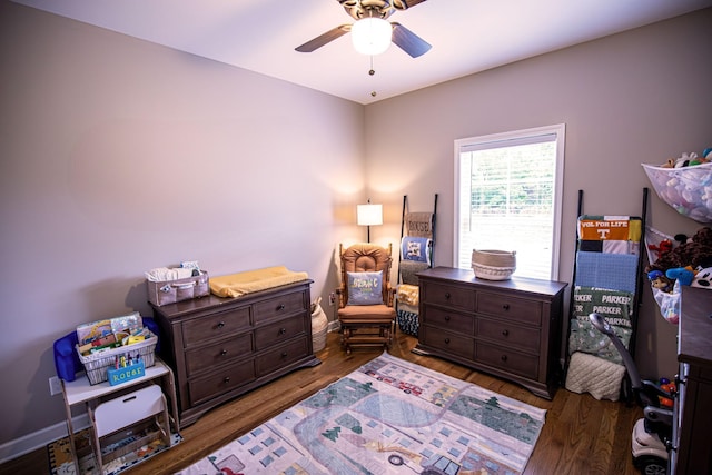 bedroom with ceiling fan, baseboards, and wood finished floors