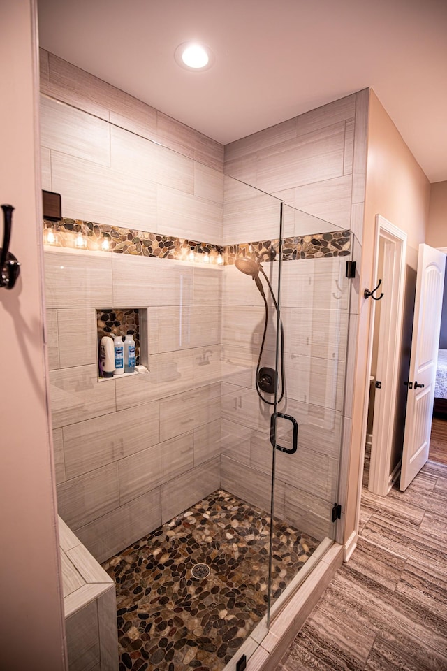 bathroom featuring a stall shower and wood finished floors