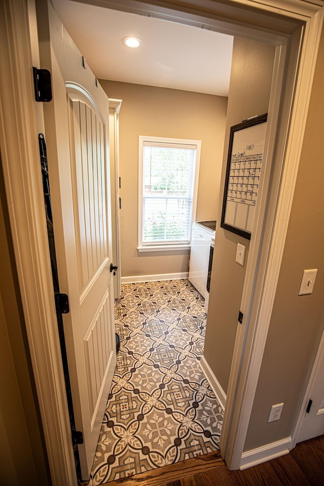 interior space featuring recessed lighting, laundry area, baseboards, tile patterned floors, and washing machine and clothes dryer