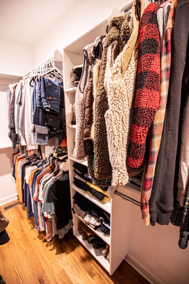 walk in closet with visible vents and wood finished floors