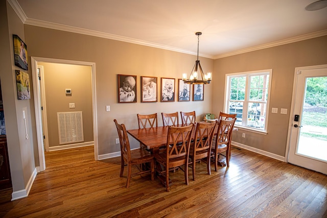 dining room with visible vents, dark wood-type flooring, and ornamental molding