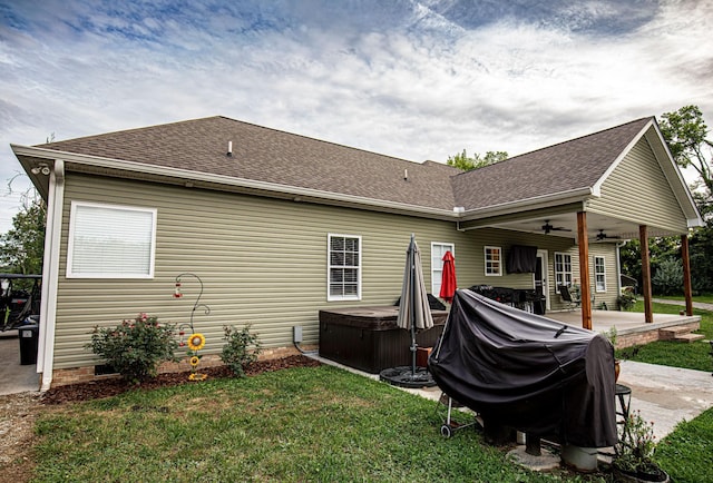 back of house featuring a patio area, a hot tub, a ceiling fan, and roof with shingles