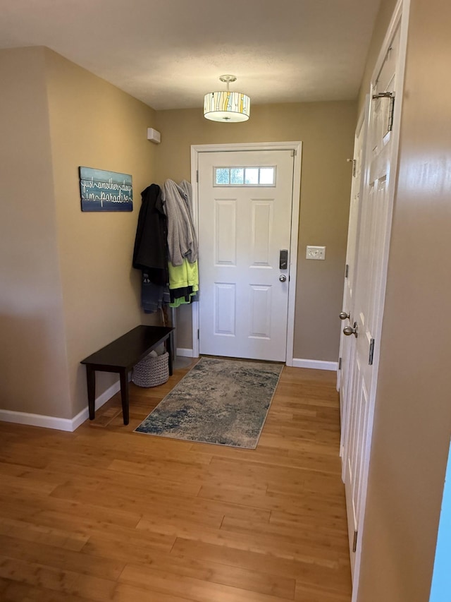 foyer featuring light wood finished floors and baseboards