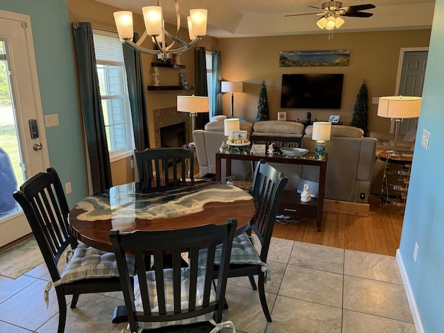 dining area with a healthy amount of sunlight, a fireplace, and tile patterned floors