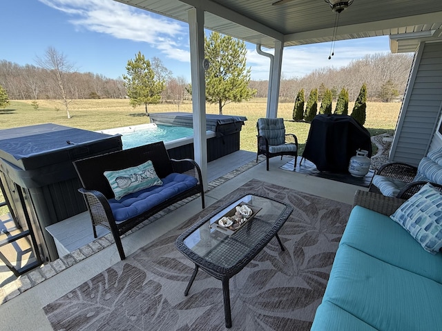 view of patio featuring outdoor lounge area and a hot tub