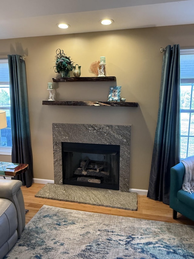 interior details featuring a high end fireplace, recessed lighting, baseboards, and wood finished floors