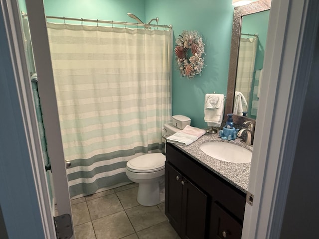 full bath featuring vanity, a shower with shower curtain, tile patterned flooring, and toilet