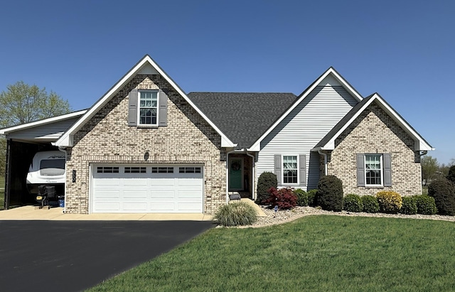 craftsman house with aphalt driveway, a front yard, and brick siding