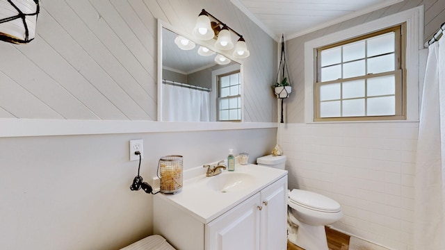 full bathroom with curtained shower, vanity, toilet, and crown molding