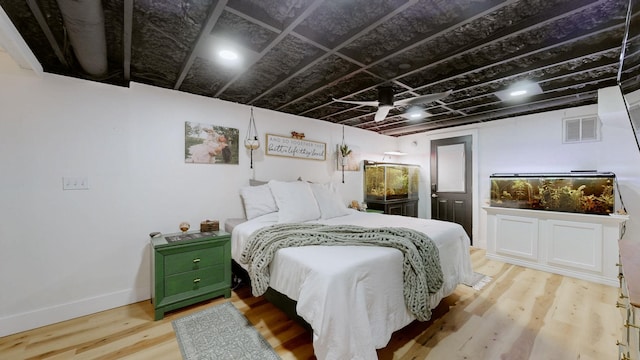 bedroom with light wood-type flooring, baseboards, and visible vents