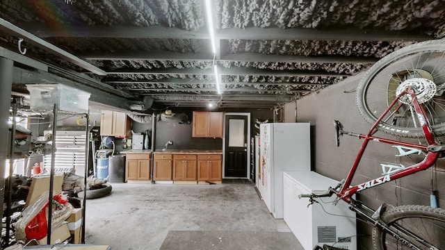 basement with freestanding refrigerator and concrete block wall