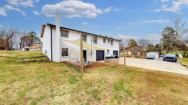 exterior space with an attached garage, brick siding, driveway, a front lawn, and a chimney