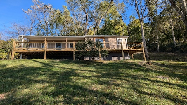 back of house featuring a lawn and a deck