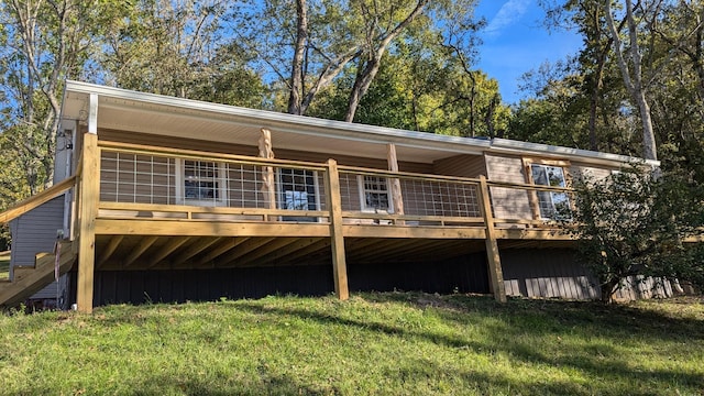 rear view of property with a lawn