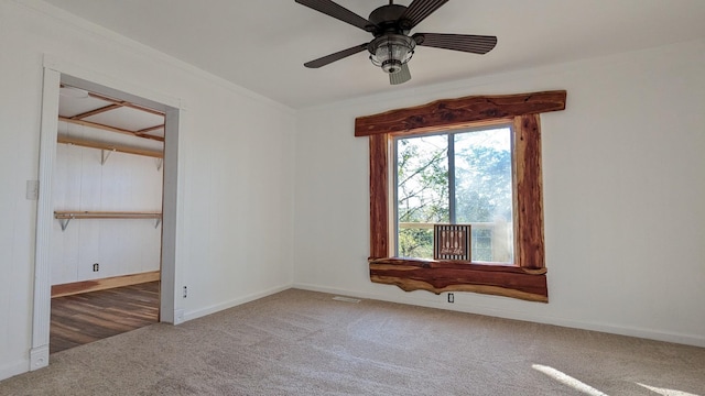 unfurnished room with a ceiling fan, carpet, visible vents, and baseboards