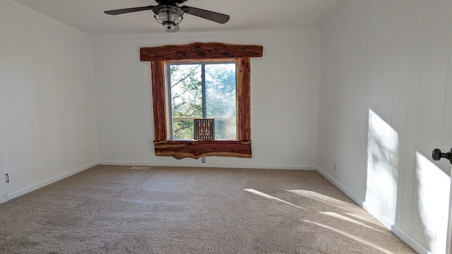 empty room with carpet, baseboards, and a ceiling fan