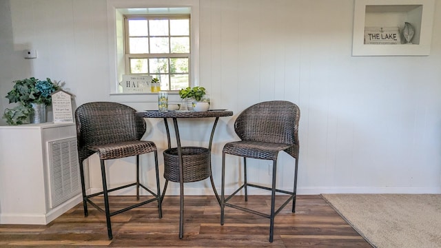 dining room featuring visible vents, baseboards, and wood finished floors