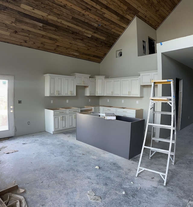 kitchen featuring high vaulted ceiling, a center island, wooden ceiling, and white cabinets