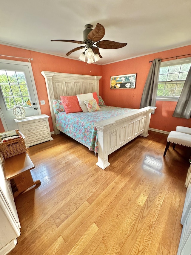 bedroom with multiple windows, a ceiling fan, light wood-type flooring, and baseboards