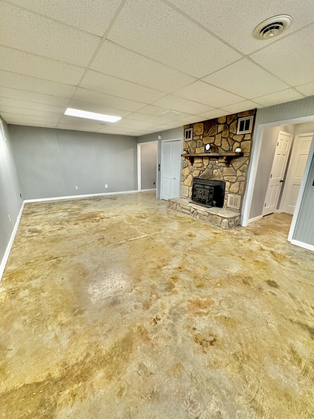 finished basement with a drop ceiling, visible vents, and baseboards