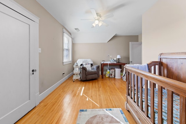 bedroom with visible vents, baseboards, light wood-style flooring, and a ceiling fan