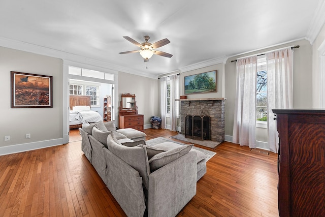 living room with a wealth of natural light, wood-type flooring, and ornamental molding