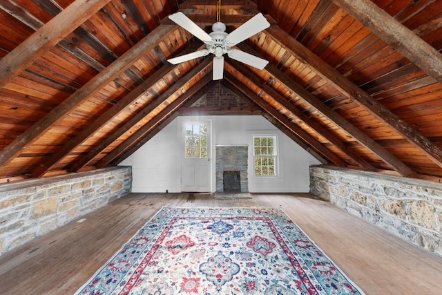 interior space featuring lofted ceiling with beams, wood finished floors, wood ceiling, and ceiling fan