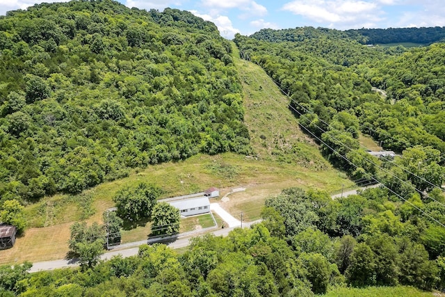 drone / aerial view featuring a forest view