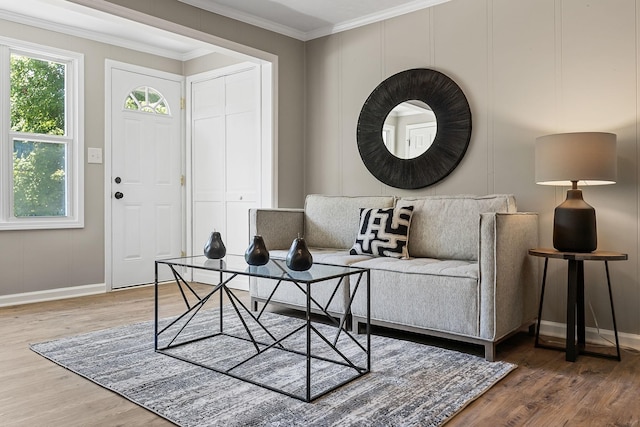 interior space featuring crown molding, baseboards, and wood finished floors