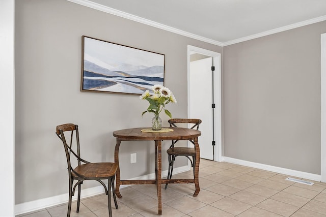 dining area with light tile patterned floors, visible vents, baseboards, and ornamental molding